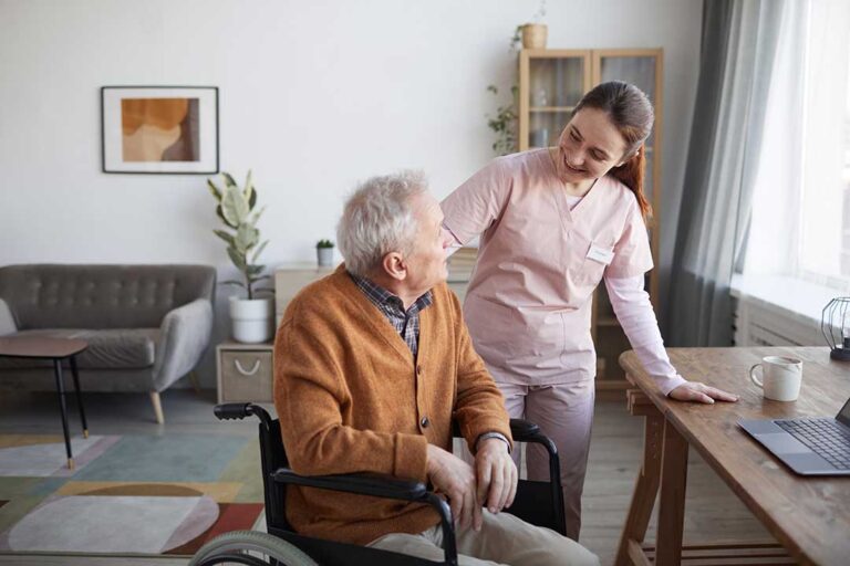 An older adult using a walker along a bright, clutter-free hallway with supportive handrails.